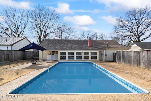 view of swimming pool featuring a patio area, a fenced in pool, and a fenced backyard