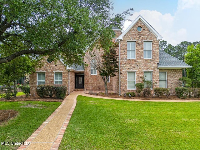 19648 Champion Cir, Gulfport, MS 39503 - view of front of property featuring a front lawn, a shingled roof, and brick siding