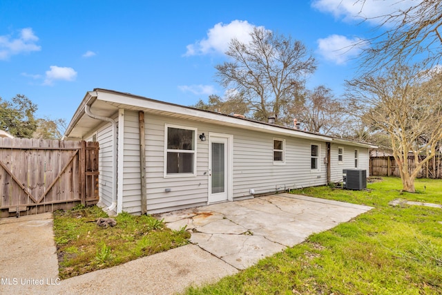 rear view of house featuring a yard, a patio area, fence, and central air condition unit