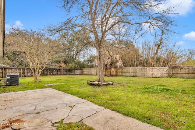 view of yard with a patio, a fenced backyard, and cooling unit