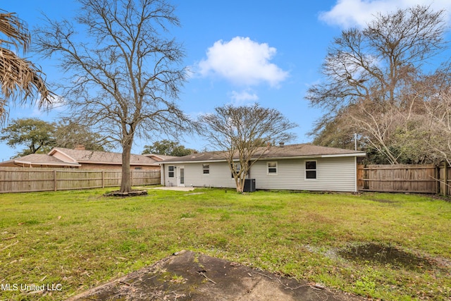 back of property featuring a patio area, a yard, and a fenced backyard