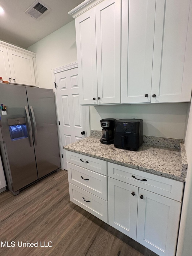 126 Deerfield Trce, Coldwater, MS 38618 - kitchen with stainless steel fridge, dark wood-style floors, and white cabinetry
