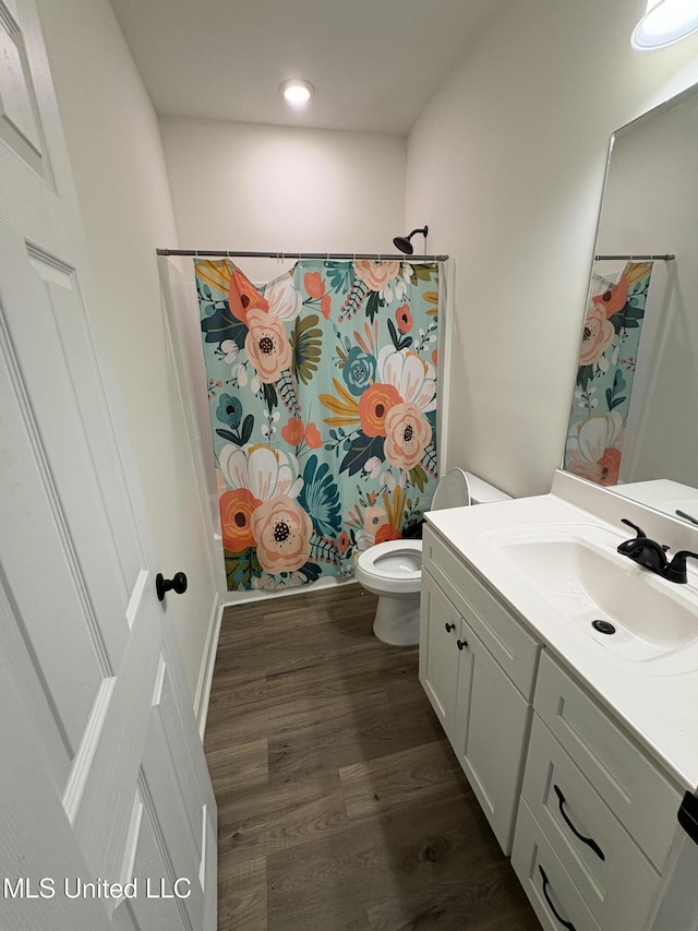126 Deerfield Trce, Coldwater, MS 38618 - full bathroom featuring vanity, toilet, wood finished floors, and a shower with shower curtain