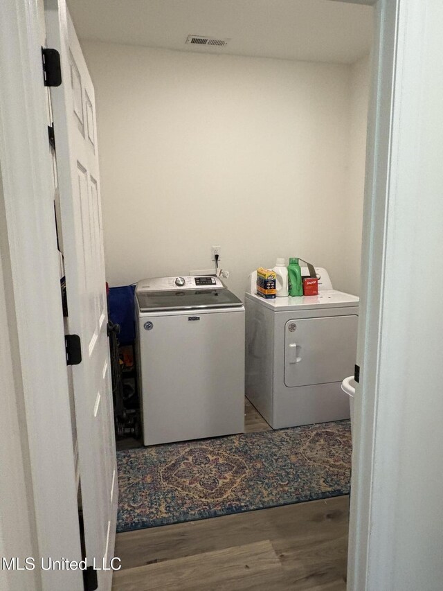 126 Deerfield Trce, Coldwater, MS 38618 - laundry room featuring washer and clothes dryer and wood finished floors