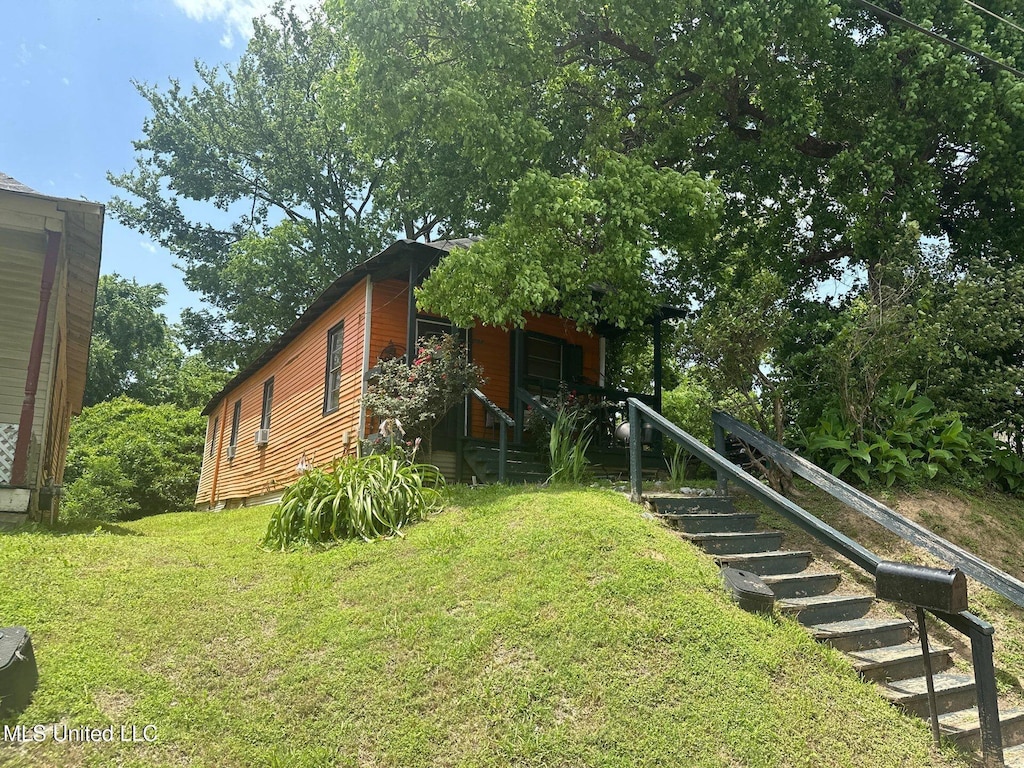 1002 Howard St, Vicksburg, MS 39183 - view of property exterior with a lawn and stairway