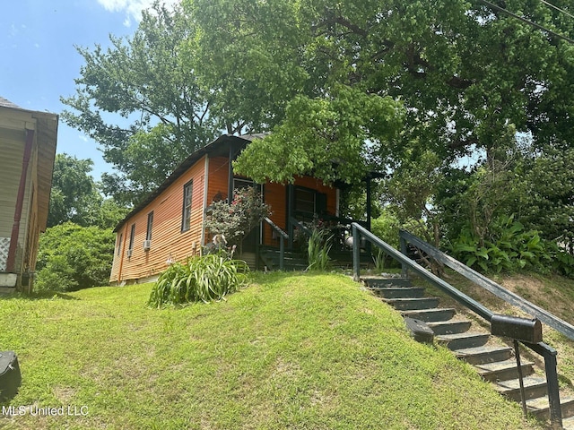 1002 Howard St, Vicksburg, MS 39183 - view of property exterior with a lawn and stairway