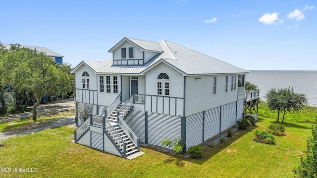 7101 Belle Fontaine Dr, Ocean Springs, MS 39564 - view of front of home with a front yard, stairs, a water view, and a metal roof
