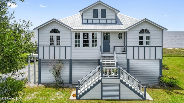 7101 Belle Fontaine Dr, Ocean Springs, MS 39564 - view of front facade with a front lawn, stairway, covered porch, and a metal roof