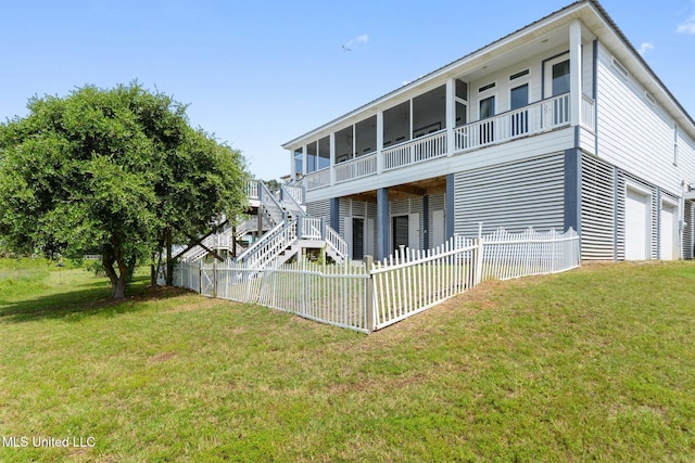 7101 Belle Fontaine Dr, Ocean Springs, MS 39564 - rear view of house with a fenced backyard, a sunroom, and a garage