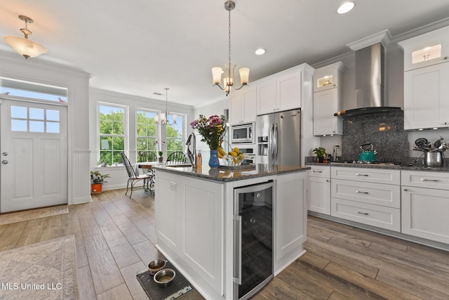 7101 Belle Fontaine Dr, Ocean Springs, MS 39564 - kitchen with appliances with stainless steel finishes, beverage cooler, a chandelier, wall chimney exhaust hood, and crown molding