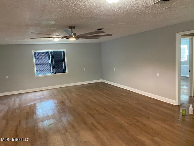 empty room with ceiling fan, a textured ceiling, and hardwood / wood-style flooring