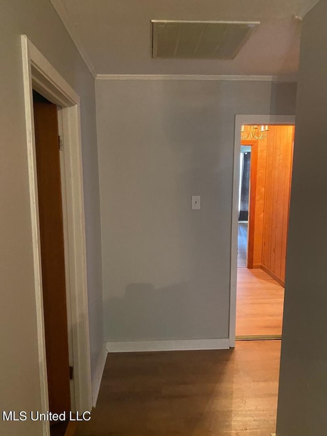 hall featuring wood-type flooring and ornamental molding