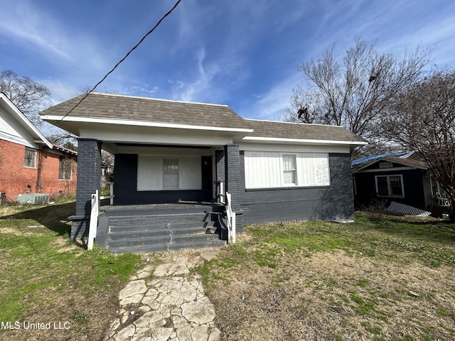 1004 Spengler St, Jackson, MS 39202 - view of front facade featuring covered porch, brick siding, and a front yard
