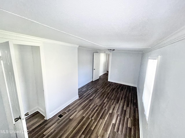 1004 Spengler St, Jackson, MS 39202 - empty room featuring baseboards, crown molding, a textured ceiling, and dark wood-style flooring