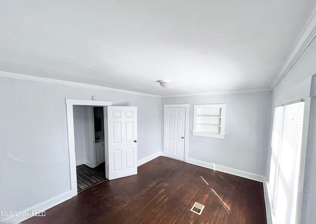 1004 Spengler St, Jackson, MS 39202 - unfurnished bedroom featuring baseboards, wood finished floors, crown molding, and a closet