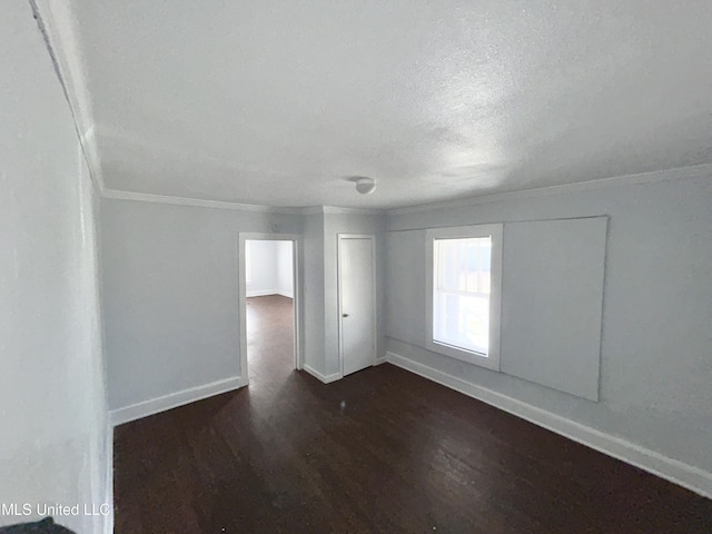 1004 Spengler St, Jackson, MS 39202 - unfurnished room featuring ornamental molding, dark wood-type flooring, baseboards, and a textured ceiling