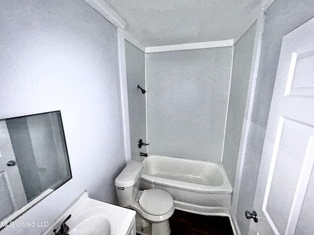 1004 Spengler St, Jackson, MS 39202 - full bathroom featuring toilet, a textured ceiling, vanity, washtub / shower combination, and wood finished floors