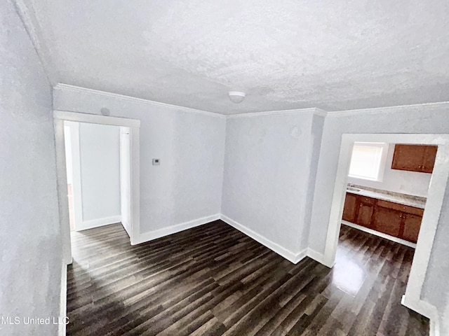 1004 Spengler St, Jackson, MS 39202 - unfurnished room featuring ornamental molding, dark wood-type flooring, a textured ceiling, and baseboards