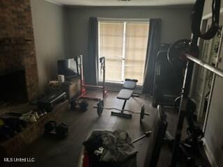 exercise room featuring a fireplace and plenty of natural light