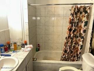 full bathroom featuring vanity, toilet, and shower / bath combo with shower curtain