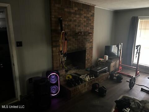 living room with crown molding and hardwood / wood-style floors