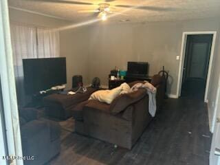 living room featuring dark hardwood / wood-style flooring and ceiling fan