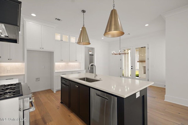 125 Water St, Madison, MS 39110 - kitchen with decorative backsplash, white cabinets, light countertops, light wood-type flooring, and recessed lighting