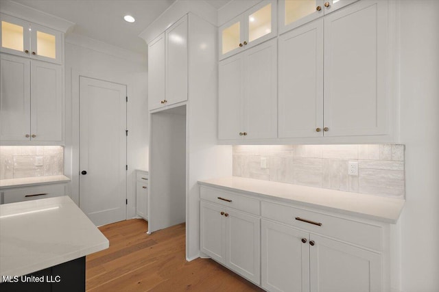 125 Water St, Madison, MS 39110 - kitchen with light countertops, backsplash, white cabinets, light wood finished floors, and recessed lighting