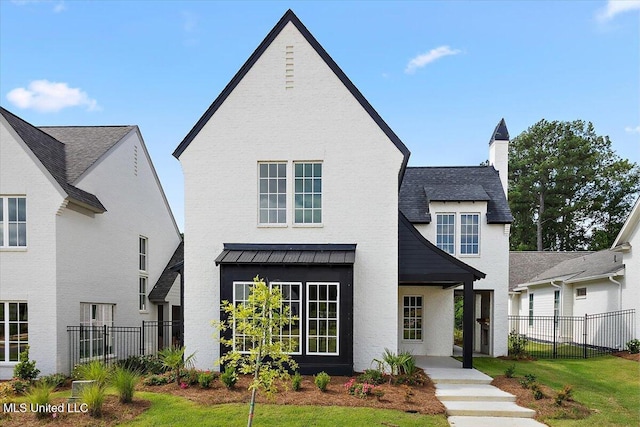 125 Water St, Madison, MS 39110 - view of front of home with a chimney and a standing seam roof