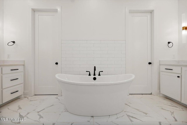 125 Water St, Madison, MS 39110 - bathroom with marble look tile flooring, vanity, and a freestanding tub