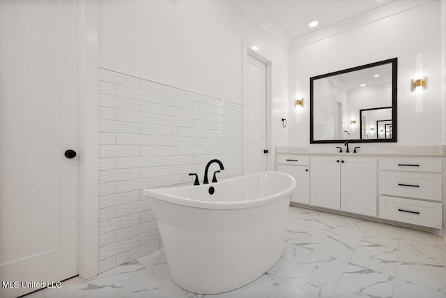 125 Water St, Madison, MS 39110 - full bath with marble look tile flooring, a soaking tub, vanity, tile walls, and crown molding