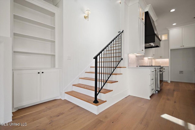 125 Water St, Madison, MS 39110 - stairs featuring wood finished floors, recessed lighting, and built in shelves
