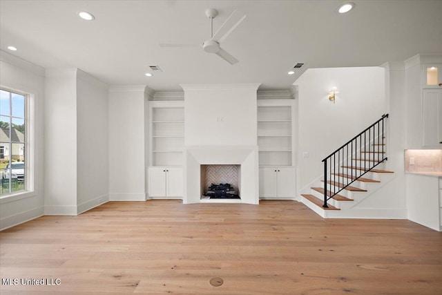 125 Water St, Madison, MS 39110 - unfurnished living room with a fireplace, a ceiling fan, light wood-style floors, stairway, and recessed lighting