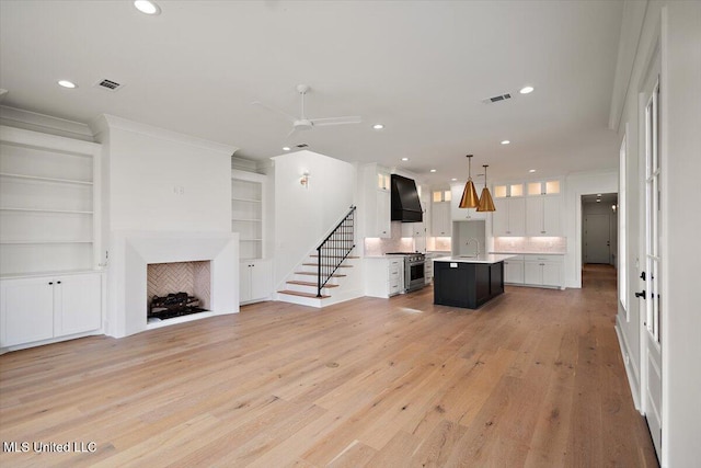 125 Water St, Madison, MS 39110 - unfurnished living room featuring light wood-style floors, stairway, recessed lighting, a ceiling fan, and built in shelves