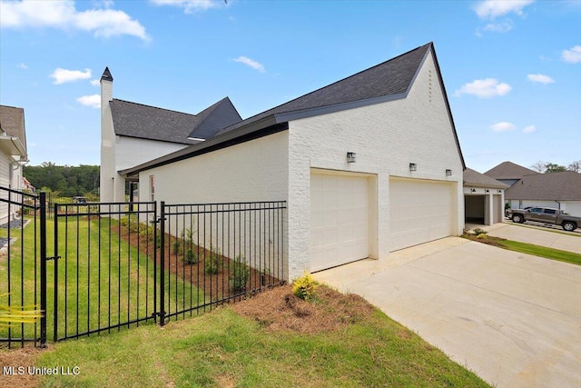 125 Water St, Madison, MS 39110 - view of side of home featuring a garage, stucco siding, a shingled roof, and driveway
