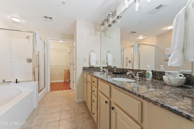 bathroom featuring tile patterned flooring, vanity, and separate shower and tub