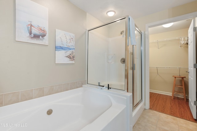 bathroom featuring tile patterned flooring and plus walk in shower