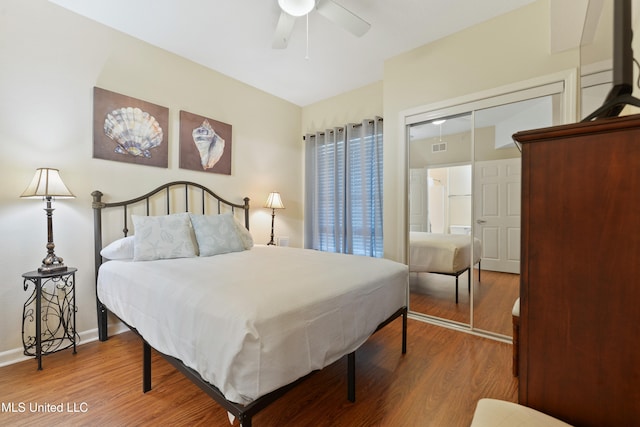 bedroom featuring ceiling fan, a closet, and hardwood / wood-style flooring