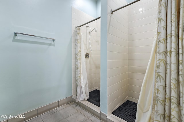 bathroom with tile patterned floors and curtained shower