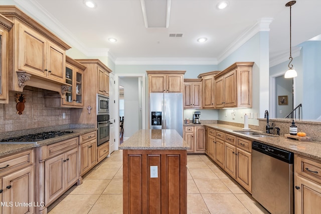 kitchen with a center island, stainless steel appliances, visible vents, a sink, and light stone countertops