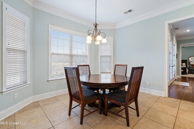 dining room with ornamental molding, light tile patterned flooring, visible vents, and baseboards