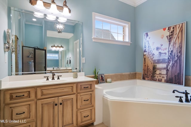 bathroom featuring ornamental molding, vanity, an inviting chandelier, and a bath