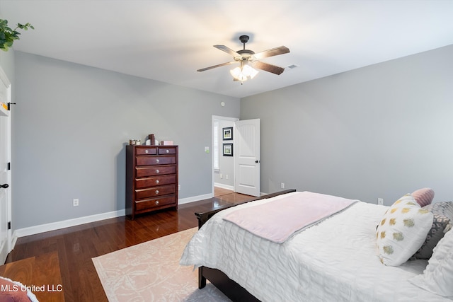 bedroom with visible vents, baseboards, ceiling fan, and wood finished floors