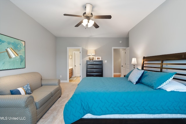 bedroom with a ceiling fan, light carpet, baseboards, and ensuite bathroom