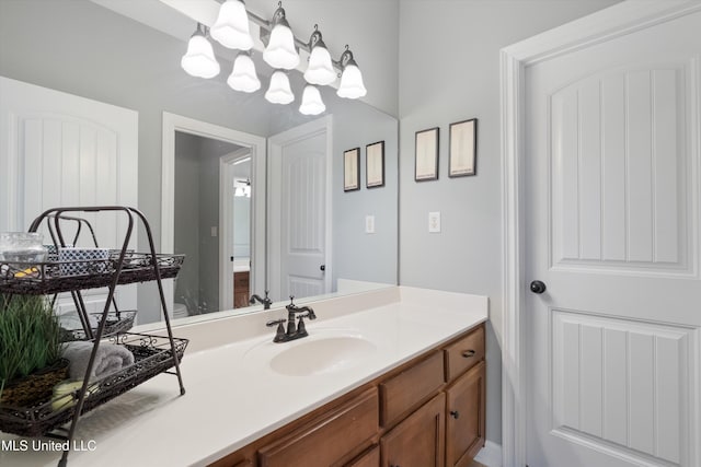 bathroom with vanity and an inviting chandelier