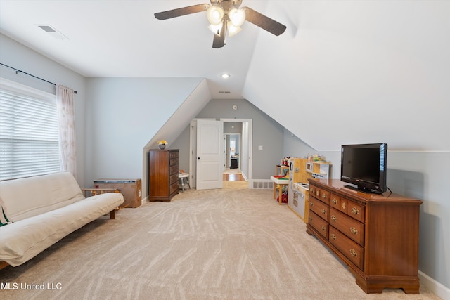 interior space featuring light carpet, lofted ceiling, visible vents, and baseboards