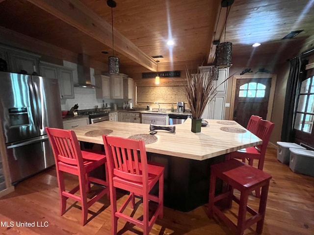 dining area featuring beamed ceiling, wood ceiling, dark hardwood / wood-style floors, and sink