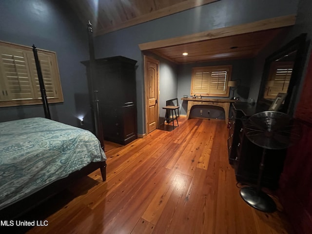 bedroom with hardwood / wood-style floors and a barn door