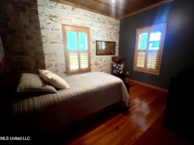 bedroom with crown molding and hardwood / wood-style floors