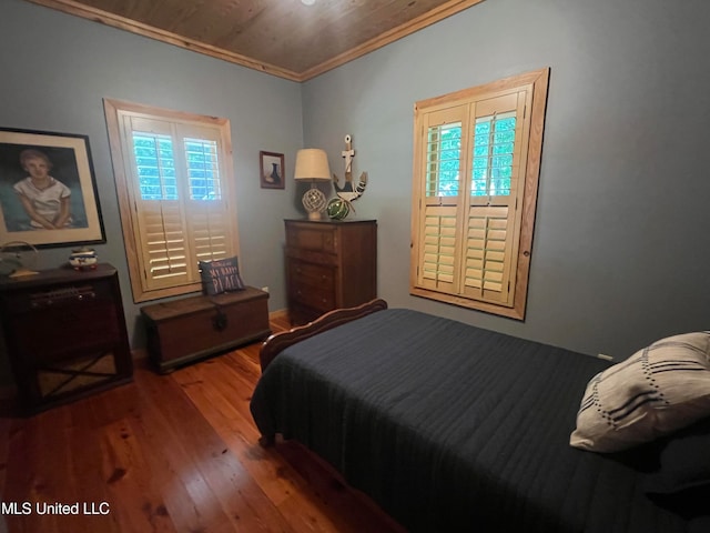 bedroom featuring crown molding and hardwood / wood-style flooring